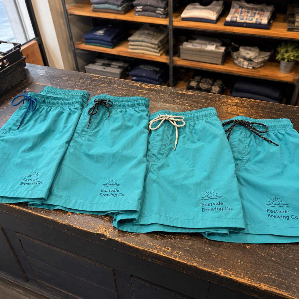 Custom boardshorts with logo hanging to dry
