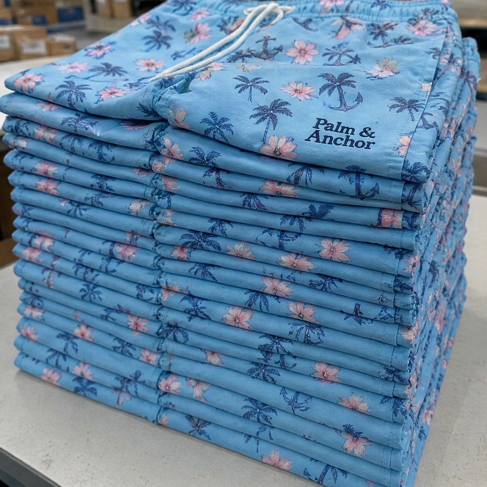 Custom printed swim trunks in bulk stacked for a team order